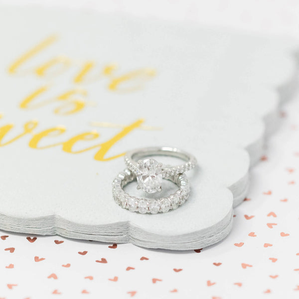 diamond ring and band laying on white pad