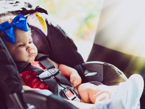 Baby girl sitting in a carseat