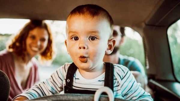 Cute baby in car with parents