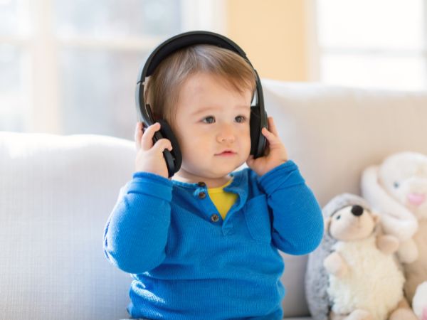 little boy with kids headphones