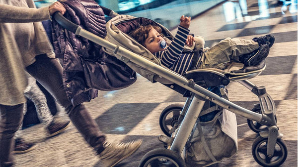Mom pushing baby in a stroller at the airport