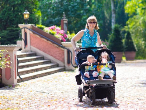 Mum pushing kids in a double stroller