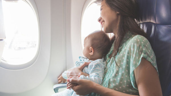 mom and child looking out plane window
