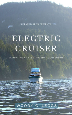 An electric cabin cruiser departs a scenic harbor in the pacific northwest.
