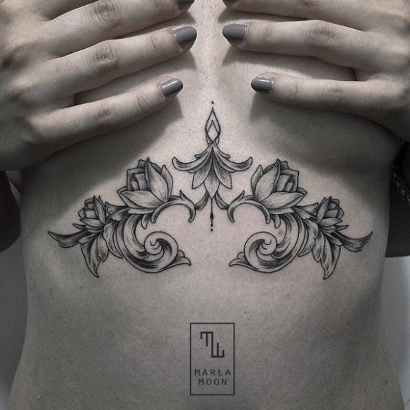 Scrolling floral sternum tattoo