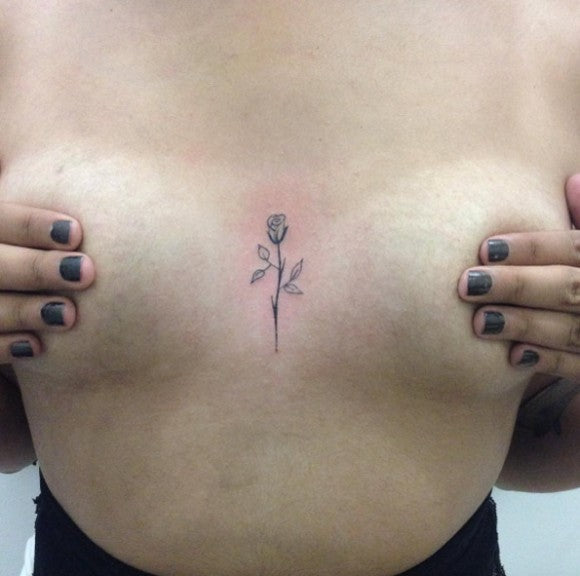 Tiny rose sternum tattoo