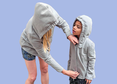 Woman Zipping Up Child's Sensory-Friendly Hoodie