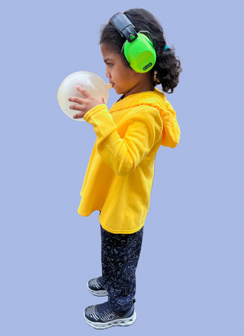 Sensory friendly joggers paired with fine motor friendly hoodie. Accessorized with sound canceling headphones and sensory balloon.