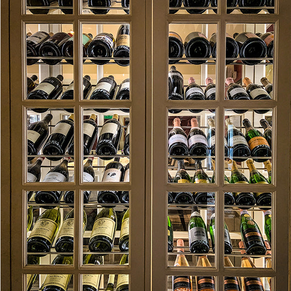 A beautiful wine cabinet stocked with bottles