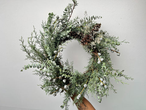 Blue Wreath featuring Eastern white cedar, spiral eucalyptus, silver bells, pine cones and the most ethereal dried baby’s breath