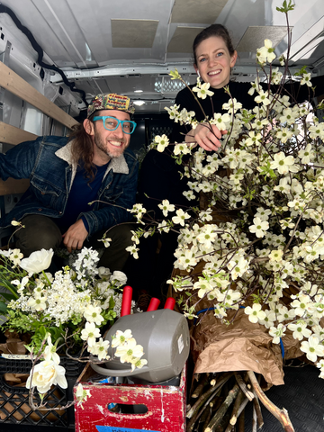 josh and paige delivering flower subscription arrangements around nyc in truck