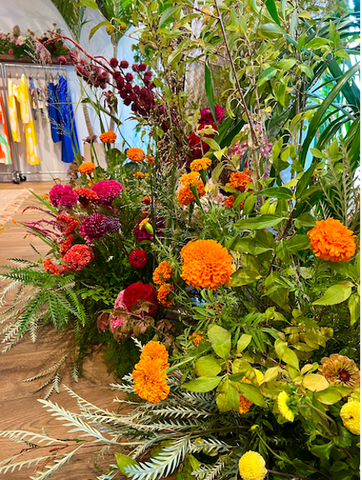 Molly Oliver Flowers for Mara Hoffman NYFW 23 Orange Marigold pink Celosia Castor bean