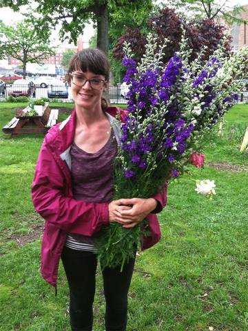 Molly Oliver Cuver urban flower farmer holding Larkspur in Crown Heights Brooklyn 2014 urban educational farm