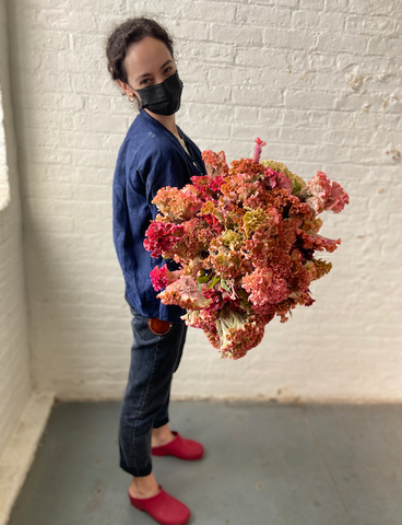 Molly Oliver Flowers Fall Seasonal Flowers florist Sophie Bromberg holding giant bunch of  Celosia Fruit Punch