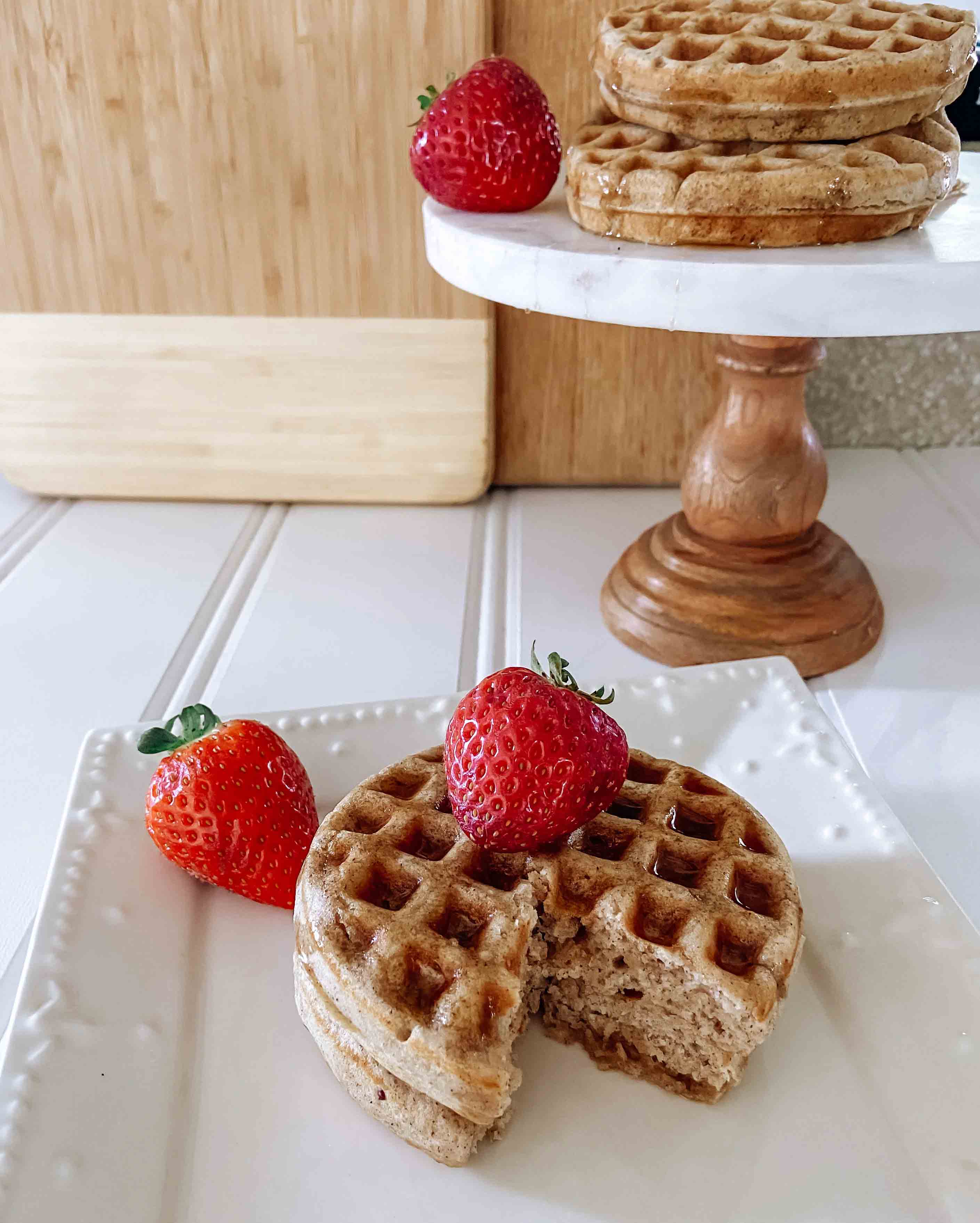 keto-friendly waffles on a plate with strawberries on top