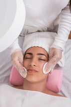 Vertical shot of hands of aesthetician performing a facial cleansing 