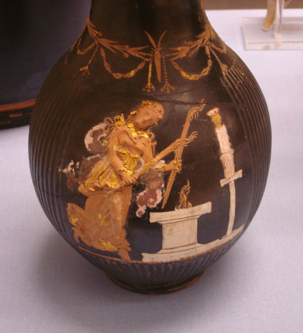 Hecate holding two torches and dancing in front of an altar, beyond which is a cult statue, ca. 350–300 BC, red-figure vase, Capua, Italy.