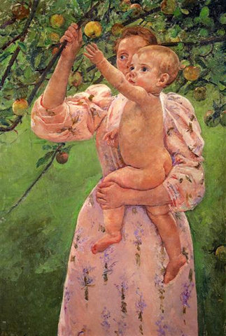 Baby held in mother's arms reaching for an apple