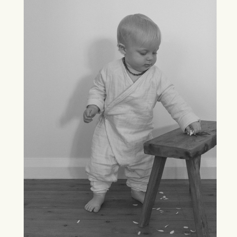 photo of standing baby at bench black and white
