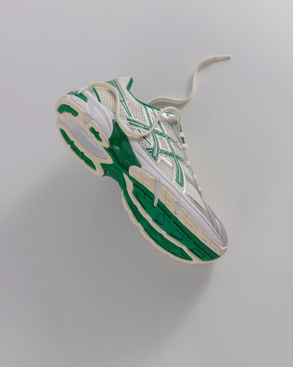 Studio image of the ASICS GEL-1130 Kale back in Cream/Kale suspended in the air