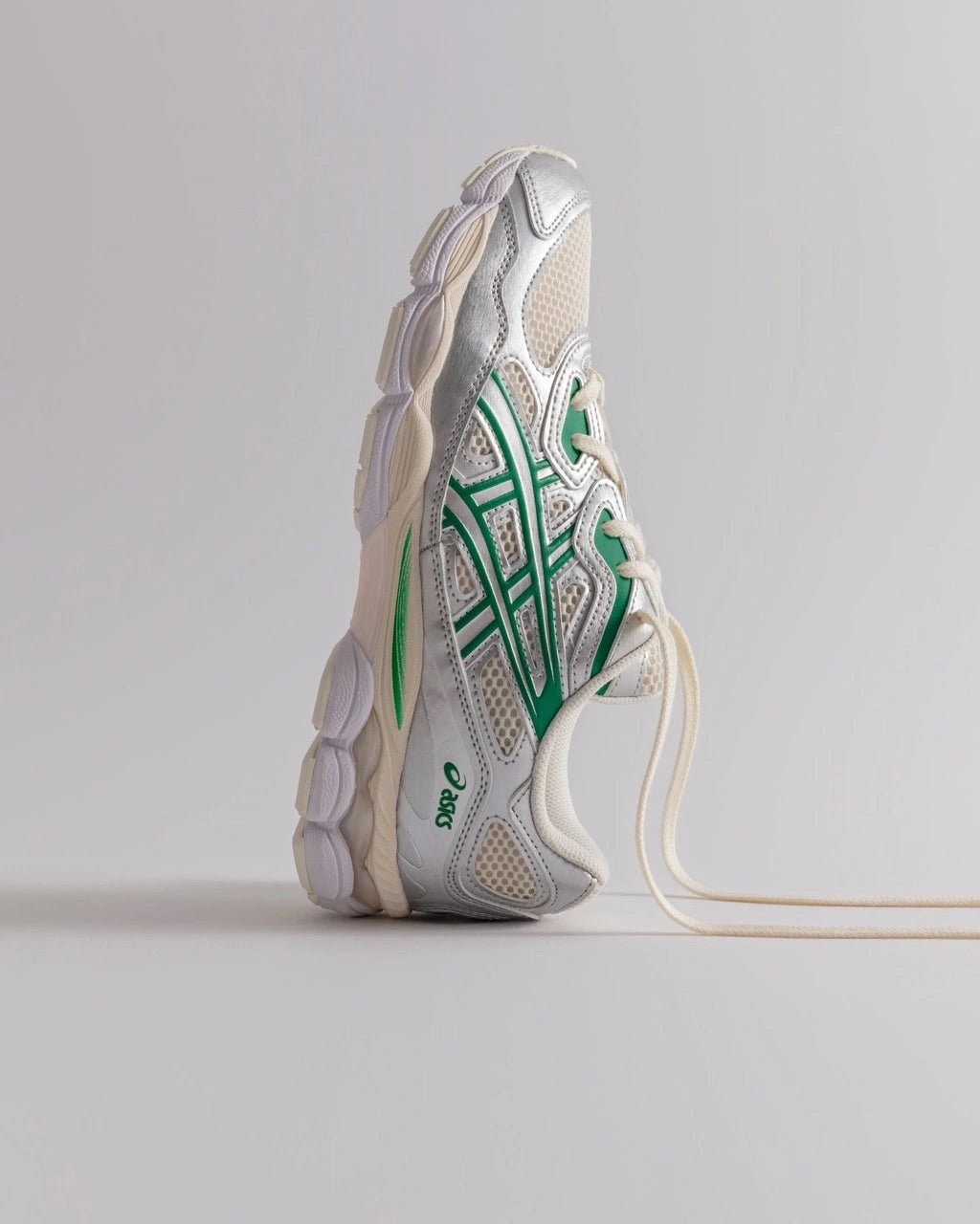 Image of a studio shot of the ASICS GEL-NYC on a studio background suspended upwards