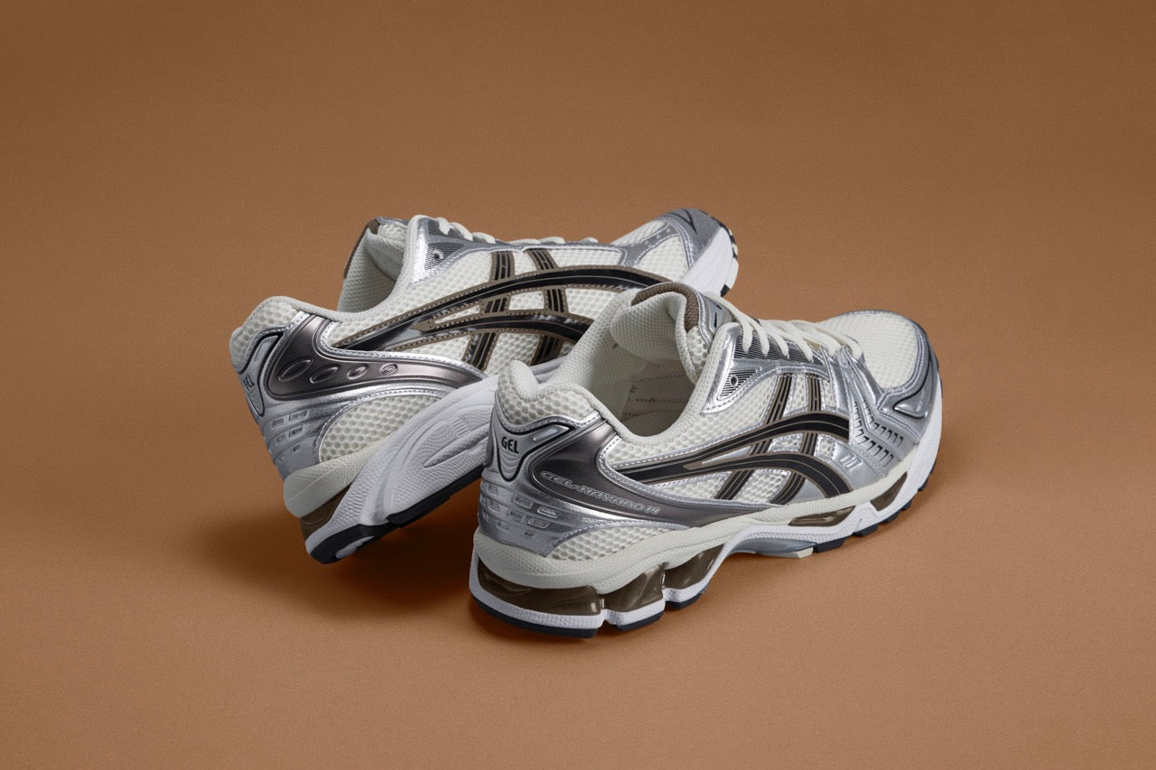 ASICS GEL-NYC sneakers in Ivory/Clay Grey colorway, showcasing a subtle mix of off-white and earthy grey, inspired by both heritage and modern performance running styles.