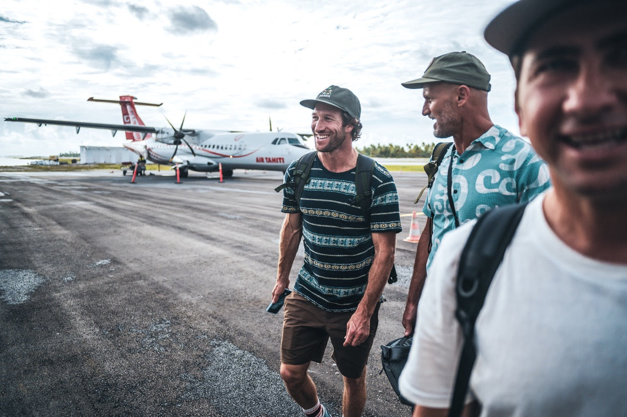 Man on an adventure in Tahiti airport wearing the Roark Sunburst Pocket Crew Tee