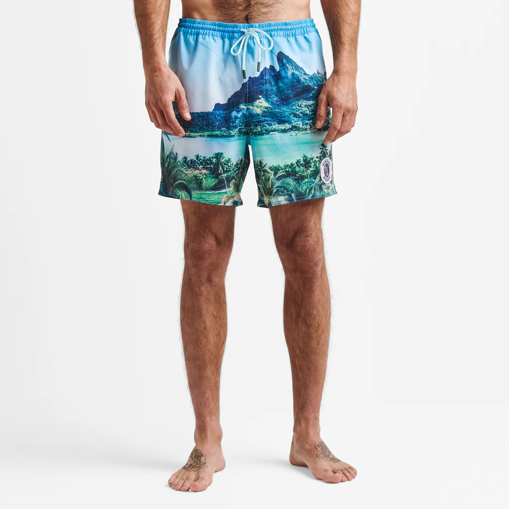 Close-up shot of a man wearing the Roark Shorey Boardshorts 16” - Hinano Sun God Light Blue, emphasizing the Bora Bora Island-inspired design, portraying a relaxed and confident vibe.