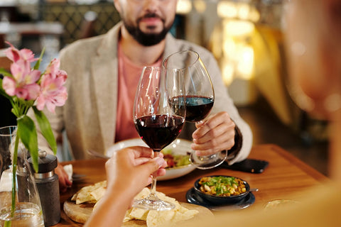 a couple having red wine