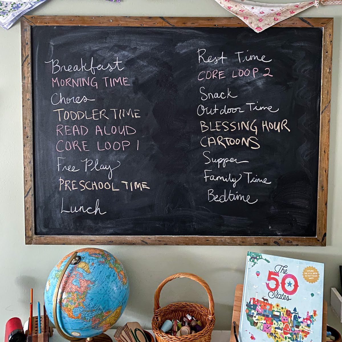 homeschool schedule written on a chalkboard.
