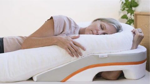 Woman sleeping on MedCline's Reflux Relief Pillow