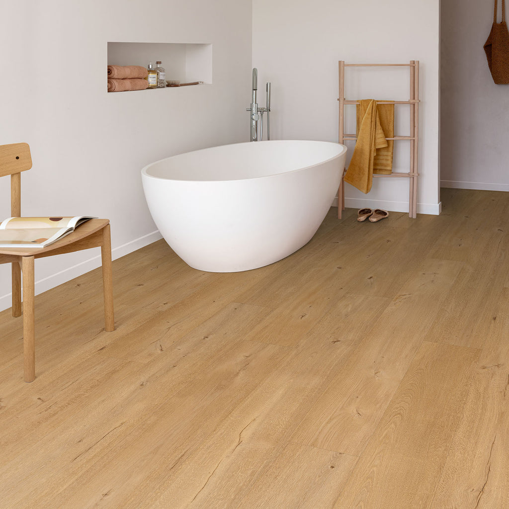 Floorify F095 Frangipane XL Vinyl Planks with a sculptural modern bath. Tiles stocked by Hyperion Tiles