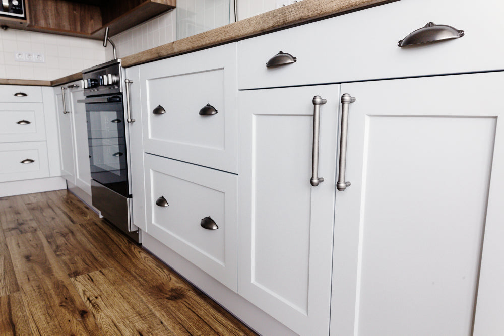 Luxury modern kitchen furniture in grey color and steel handle, oven, sink, wooden tabletop and floor