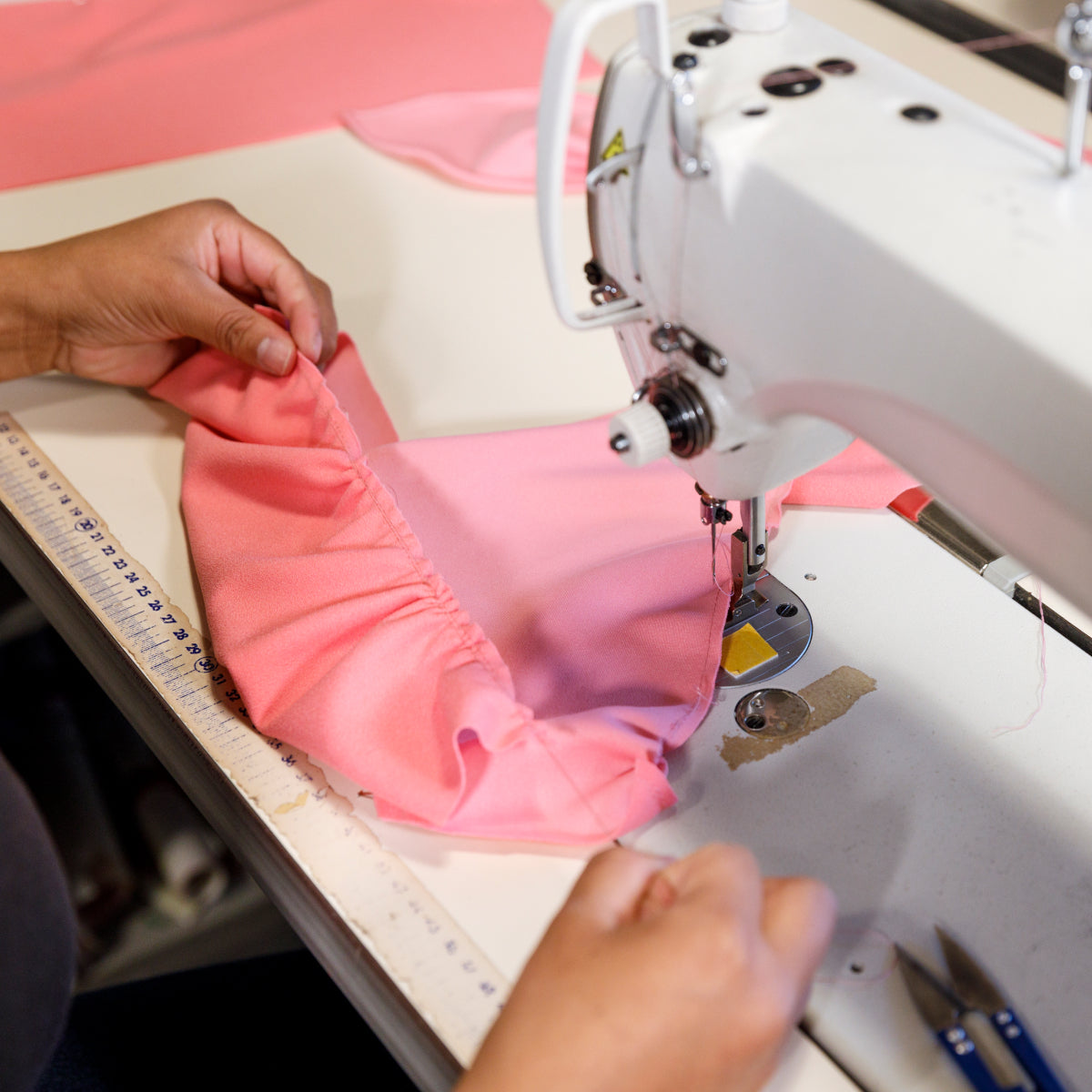 Woman fixing clothes on the sewing machine