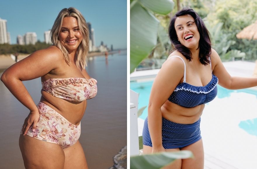 Woman with blonde hair poses on the beach wearing pale pink strapless bikini top and high waisted pants. Woman with dark brown hair wears navy bandeau bikini with white polkadots.