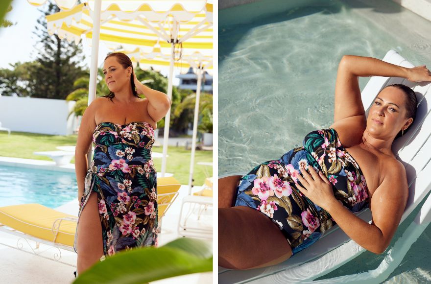 Woman with slicked back brown hair poses by the pool wearing tropical print strapless one piece swimsuit