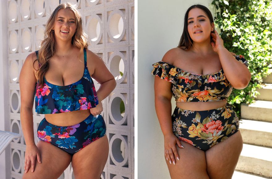Woman with long blonde hair wears navy and floral frill bikini top and high waisted pant. Woman with long brown hair wears off the shoulder bikini top and pant in black and orange floral print.