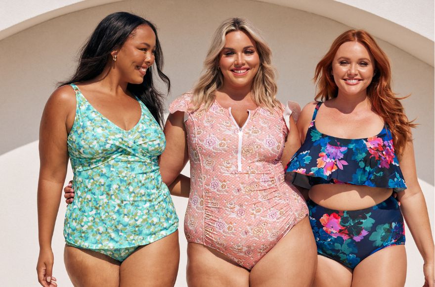 3 women pose together wearing different swimsuit styles.