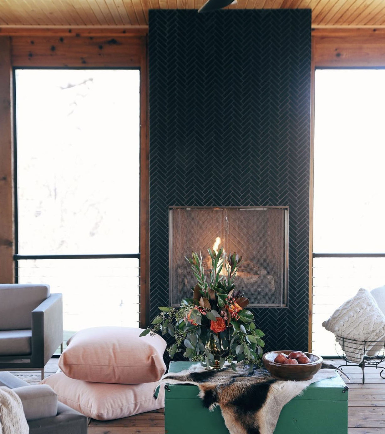 black tile fireplace on screened in porch