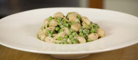Gnocchi Pillows with Caramelized Onion, Peas, Parmesan, and Cream