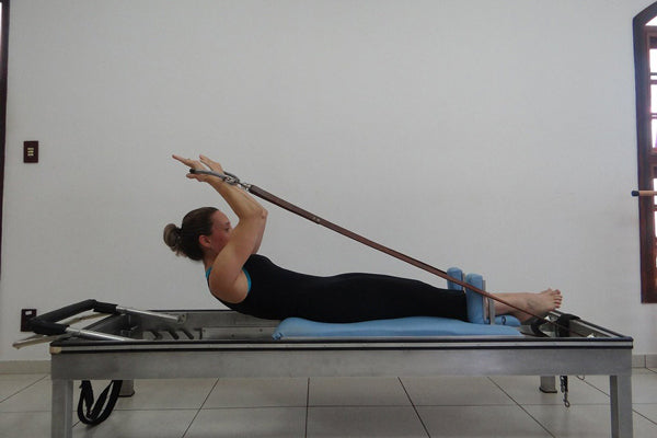 woman using reformer carriage bed