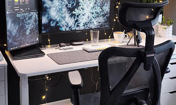 Minimal white desk with 24-inch monitor, ergonomic chair and soft ambient lighting