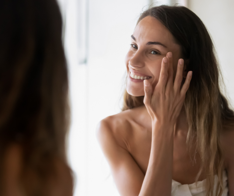 Woman applying tallow to fer face