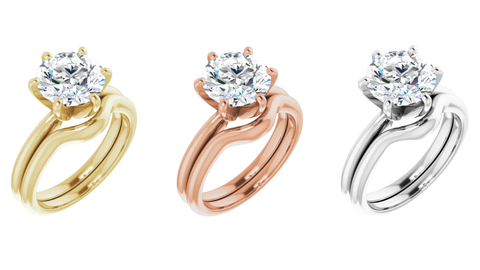 Three engagement rings that are precious metals, one rose gold, yellow gold and white gold