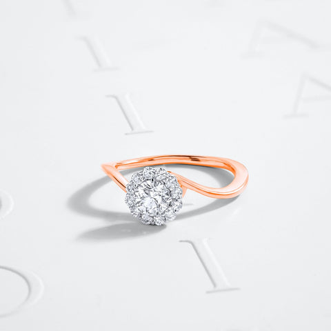 A luxury rose gold sustainable diamond ring laying flat for display.