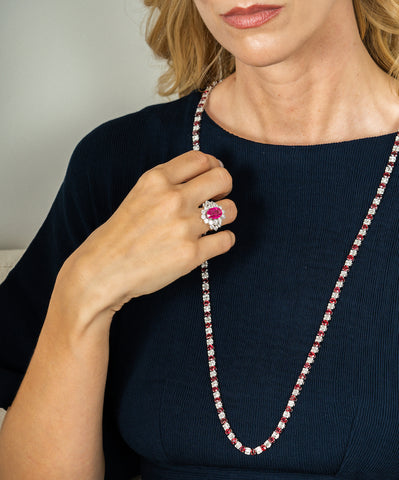 Woman wearing the ruby fire and ice necklace and a pink ring