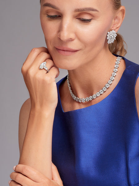 Woman with diamond necklace, earring, and ring