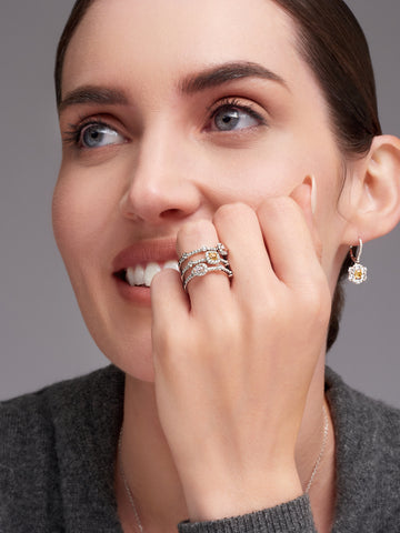 woman with multicolored diamond rings and earring