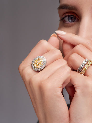 Yellow diamond ring on a woman's hand