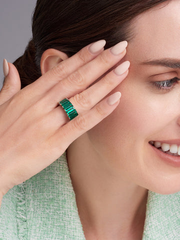 woman wearing a natural emerald eternity band